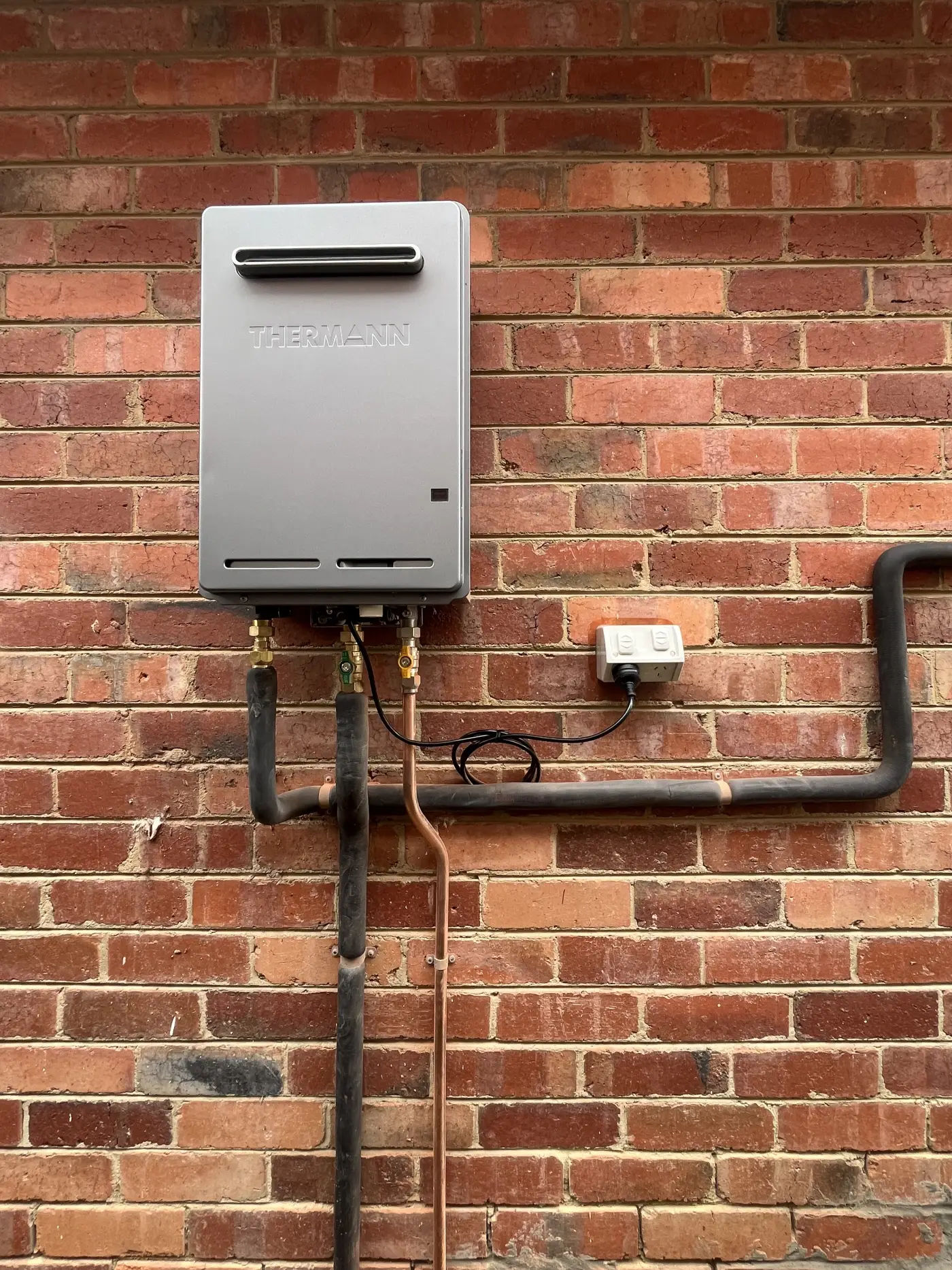 Heat pump hot water unit installed as part of a gas to electric conversion